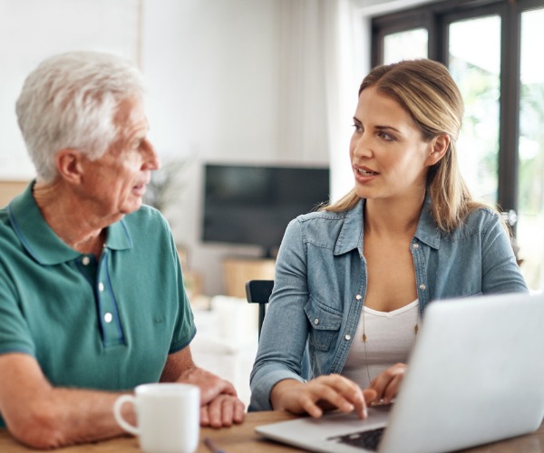 daughter helping her senior father with his estate finances