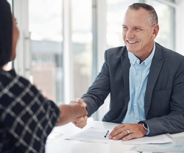 advisor shaking hand of female client